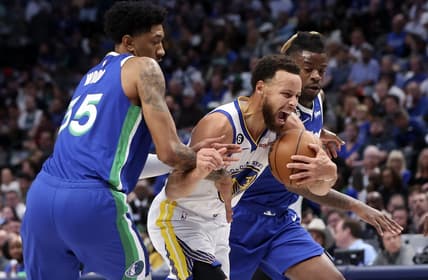 Nov 29, 2022; Dallas, Texas, USA;  Golden State Warriors guard Stephen Curry (30) drives to the basket as Dallas Mavericks center Christian Wood (35) and Dallas Mavericks forward Reggie Bullock (25) defends during the first quarter at American Airlines Center. Mandatory Credit: Kevin Jairaj-USA TODAY Sports