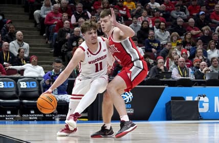 Mar 8, 2023; Chicago, IL, USA; Ohio State Buckeyes guard Sean McNeil (4) defends Wisconsin Badgers guard Max Klesmit (11) during the first half at United Center. Mandatory Credit: David Banks-USA TODAY Sports
