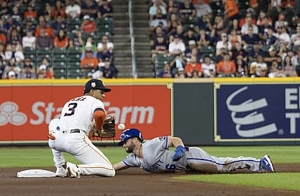 Jul 6, 2022; Houston, Texas, USA; Kansas City Royals left fielder Andrew Benintendi (16) steals second base against Houston Astros shortstop Jeremy Pena (3) in the first inning at Minute Maid Park. Mandatory Credit: Thomas Shea-USA TODAY Sports