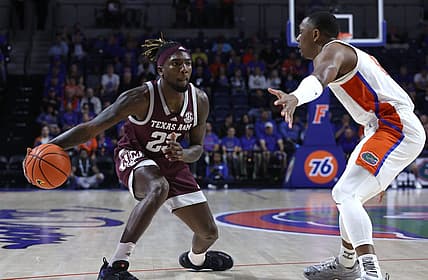 Jan 4, 2023; Gainesville, Florida, USA; Texas A&M Aggies guard Tyrece Radford (23) passes the ball as Florida Gators guard Kyle Lofton (11) defends during the first half at Exactech Arena at the Stephen C. O Connell Center. Mandatory Credit: Kim Klement-USA TODAY Sports