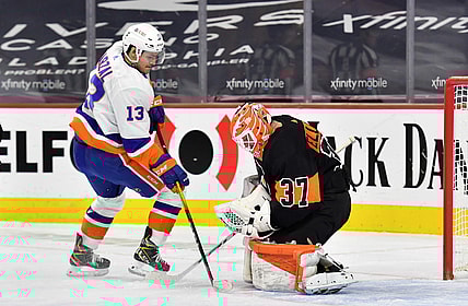 Jan 31, 2021; Philadelphia, Pennsylvania, USA; Philadelphia Flyers goaltender Brian Elliott (37) covers the puck against New York Islanders center Mathew Barzal (13) during the first period at Wells Fargo Center. Mandatory Credit: Eric Hartline-USA TODAY Sports