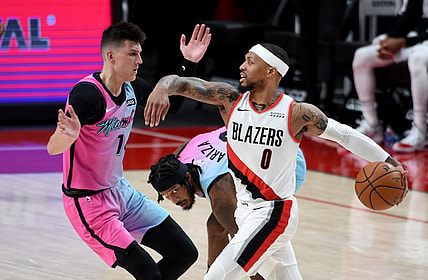 Apr 11, 2021; Portland, Oregon, USA; Portland Trail Blazers guard Damian Lillard (0) drives to the basket on Miami Heat guard Tyler Herro (14) during the first half of the game at Moda Center. Mandatory Credit: Steve Dykes-USA TODAY Sports