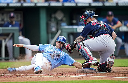 Jun 19, 2021; Kansas City, Missouri, USA; Kansas City Royals right fielder Whit Merrifield (15) is tagged out at home by Boston Red Sox catcher Christian Vazquez (7) during the first inning at Kauffman Stadium. Mandatory Credit: Jay Biggerstaff-USA TODAY Sports