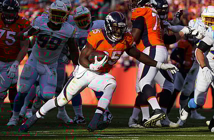 Nov 28, 2021; Denver, Colorado, USA; Denver Broncos running back Melvin Gordon (25) carries the ball in the first half against the Los Angeles Chargers at Empower Field at Mile High. Mandatory Credit: Ron Chenoy-USA TODAY Sports