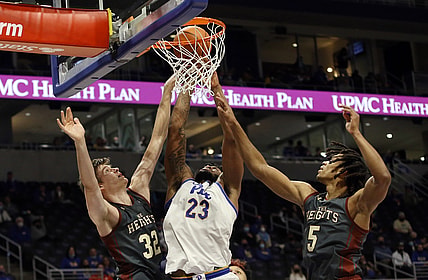 Jan 8, 2022; Pittsburgh, Pennsylvania, USA;  Pittsburgh Panthers forward John Hugley (23) shoots as Boston College Eagles center Justin Vander Baan (32) and guard DeMarr Langford Jr. (5) defend during the second half at the Petersen Events Center. The Panthers won 69-67. Mandatory Credit: Charles LeClaire-USA TODAY Sports