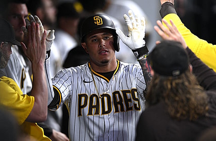 Jul 7, 2022; San Diego, California, USA; San Diego Padres third baseman Manny Machado (13) is congratulated in the dugout after hitting a home run against the San Francisco Giants during the fifth inning at Petco Park. Mandatory Credit: Orlando Ramirez-USA TODAY Sports