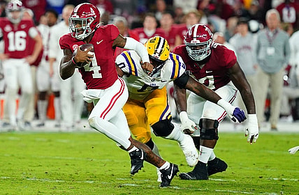 Nov 4, 2023; Tuscaloosa, Alabama, USA; Alabama Crimson Tide quarterback Jalen Milroe (4) scrambles up the field against the LSU Tigers during the second quarter at Bryant-Denny Stadium. Mandatory Credit: John David Mercer-USA TODAY Sports