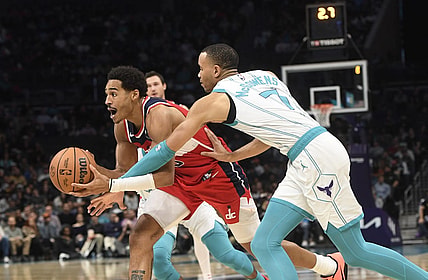 Nov 22, 2023; Charlotte, North Carolina, USA; Washington Wizards guard Jordan Poole (13) drives past Charlotte Hornets guard Bryce McGowens (7) during the second half at the Spectrum Center. Mandatory Credit: Sam Sharpe-USA TODAY Sports