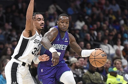 Jan 19, 2024; Charlotte, North Carolina, USA;  Charlotte Hornets guard Terry Rozier (3) moves in past the defense of San Antonio Spurs guard Tre Jones (33) during the first half at the Spectrum Center. Mandatory Credit: Sam Sharpe-USA TODAY Sports