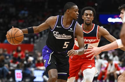 Feb 12, 2022; Washington, District of Columbia, USA; Sacramento Kings guard De'Aaron Fox (5) dribbles as Washington Wizards guard Ish Smith (4) chases during the first half at Capital One Arena. Mandatory Credit: Brad Mills-USA TODAY Sports