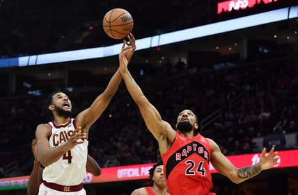 Mar 6, 2022; Cleveland, Ohio, USA; Cleveland Cavaliers center Evan Mobley (4) goes for a rebound against Toronto Raptors center Khem Birch (24) during the second half at Rocket Mortgage FieldHouse. Mandatory Credit: Ken Blaze-USA TODAY Sports