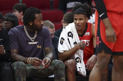 Apr 10, 2022; Houston, Texas, USA; Houston Rockets guard Jalen Green (0) talks with guard John Wall (left) during the second quarter against the Atlanta Hawks at Toyota Center. Mandatory Credit: Troy Taormina-USA TODAY Sports