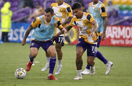 Sep 14, 2022; Orlando, Florida, USA; Orlando City SC defender Kyle Smith (24) and midfielder J  nior Urso (11) work out prior to a game against Atlanta United FC at Exploria Stadium. Mandatory Credit: Kim Klement-USA TODAY Sports