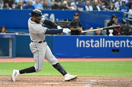 Sep 15, 2022; Toronto, Ontario, CAN; Tampa Bay Rays third baseman Yandy Diaz loses his bat during the seventh inning against the Toronto Blue Jays at Rogers Centre. Mandatory Credit: Dan Hamilton-USA TODAY Sports