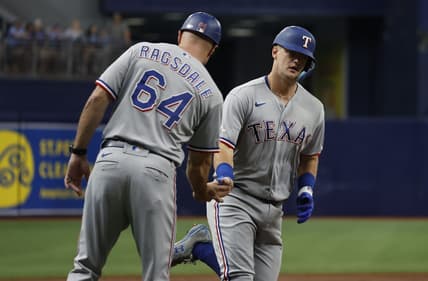 Sep 18, 2022; St. Petersburg, Florida, USA; Texas Rangers third baseman Josh Jung (6) is congratulated by Texas Rangers field coordinator/third base coach Corey Ragsdale (64) after he hit a home run against the Tampa Bay Rays during the second inning  at Tropicana Field. Mandatory Credit: Kim Klement-USA TODAY Sports