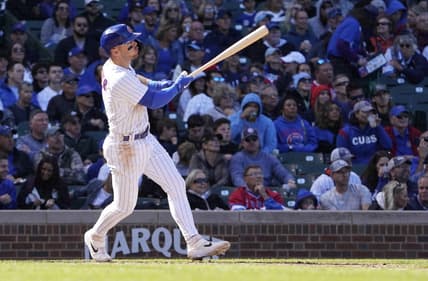 Oct 2, 2022; Chicago, Illinois, USA; Chicago Cubs shortstop Nico Hoerner (2) hits a sacrifice fly against the Cincinnati Reds during the fourth inning at Wrigley Field. Mandatory Credit: David Banks-USA TODAY Sports