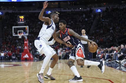 Dec 23, 2022; Houston, Texas, USA; Houston Rockets guard Kevin Porter Jr. (3) dribbles the ball as Dallas Mavericks forward Reggie Bullock (25) defends during the second quarter at Toyota Center. Mandatory Credit: Troy Taormina-USA TODAY Sports