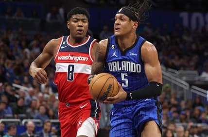 Dec 30, 2022; Orlando, Florida, USA; Orlando Magic forward Paolo Banchero (5) drives to the basket as Washington Wizards forward Rui Hachimura (8) defends during the first quarter at Amway Center. Mandatory Credit: Kim Klement-USA TODAY Sports