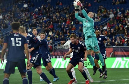 Apr 2, 2022; Foxborough, Massachusetts, USA; New England Revolution goalkeeper Brad Knighton (18) makes a corner kick save during the second half against the New York Red Bulls at Gillette Stadium. Mandatory Credit: Bob DeChiara-USA TODAY Sports