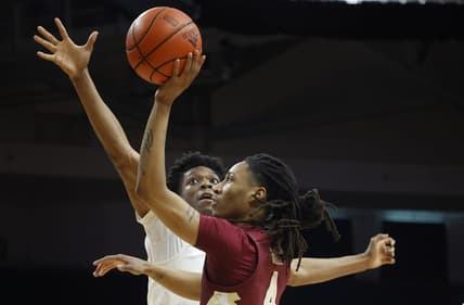 Feb 25, 2023; Coral Gables, Florida, USA; Florida State Seminoles guard Caleb Mills (4) shoots over Miami Hurricanes guard forward Anthony Walker (1) during the first half at Watsco Center. Mandatory Credit: Rhona Wise-USA TODAY Sports