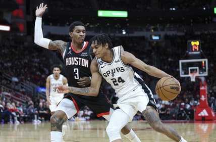 Dec 19, 2022; Houston, Texas, USA; San Antonio Spurs guard Devin Vassell (24) attempts to dribble the ball around Houston Rockets guard Kevin Porter Jr. (3) during the third quarter at Toyota Center. Mandatory Credit: Troy Taormina-USA TODAY Sports