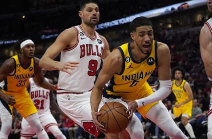 Mar 5, 2023; Chicago, Illinois, USA; Chicago Bulls center Nikola Vucevic (9) defends Indiana Pacers guard Tyrese Haliburton (0) during the first quarter at United Center. Mandatory Credit: David Banks-USA TODAY Sports
