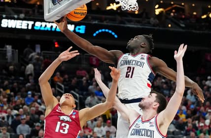 Mar 23, 2023; Las Vegas, NV, USA; UConn Huskies forward Adama Sanogo (21) grabs a rebound against Arkansas Razorbacks guard Jordan Walsh (13) during the second half at T-Mobile Arena. Mandatory Credit: Stephen R. Sylvanie-USA TODAY Sports