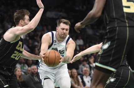 Mar 26, 2023; Charlotte, North Carolina, USA;  Dallas Mavericks guard Luka Doncic (77) drives past Charlotte Hornets forward Gordon Hayward (20) during the first half at the Spectrum Center. Mandatory Credit: Sam Sharpe-USA TODAY Sports