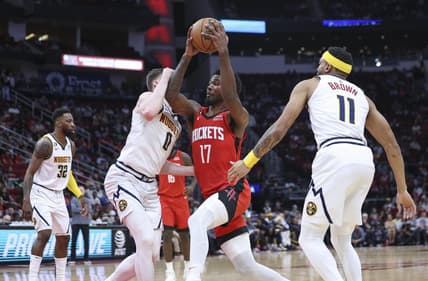 Apr 4, 2023; Houston, Texas, USA; Houston Rockets forward Tari Eason (17) drives with the ball as Denver Nuggets guard Christian Braun (0) defends during the second quarter at Toyota Center. Mandatory Credit: Troy Taormina-USA TODAY Sports