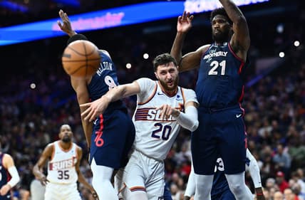 Nov 4, 2023; Philadelphia, Pennsylvania, USA; Phoenix Suns center Jusuf Nurkic (20) passes the ball between Philadelphia 76ers center Joel Embiid (21) and guard De'Anthony Melton (8) in the first quarter at Wells Fargo Center. Mandatory Credit: Kyle Ross-USA TODAY Sports