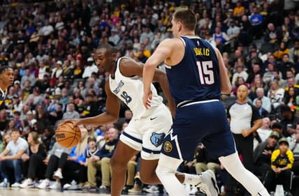 Dec 28, 2023; Denver, Colorado, USA; Memphis Grizzlies center Bismack Biyombo (18) drives at Denver Nuggets center Nikola Jokic (15) in the first quarter at Ball Arena. Mandatory Credit: Ron Chenoy-USA TODAY Sports