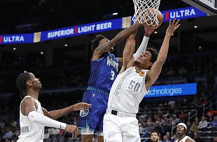 Jan 7, 2022; Oklahoma City, Oklahoma, USA; Oklahoma City Thunder forward Jeremiah Robinson-Earl (50) and Minnesota Timberwolves forward Jaden McDaniels (3) fight for a rebound during the first quarter at Paycom Center. Mandatory Credit: Alonzo Adams-USA TODAY Sports