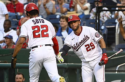 Aug 1, 2022; Washington, District of Columbia, USA; Washington Nationals right fielder Juan Soto (22) is congratulated by left fielder Yadiel Hernandez (29) after scoring a run against the New York Mets during the first inning at Nationals Park. Mandatory Credit: Brad Mills-USA TODAY Sports