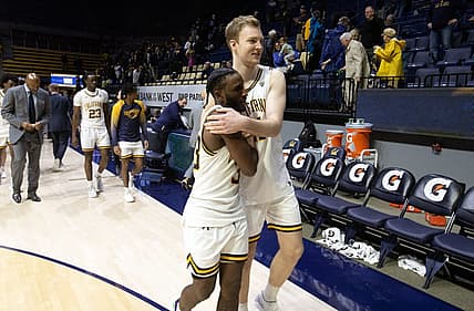 Dec 31, 2022; Berkeley, California, USA; California Golden Bears guard DeJuan Clayton (33) and forward Lars Thiemann (21) embrace after defeating the Colorado Buffaloes at Haas Pavilion. California won 80-76. Mandatory Credit: D. Ross Cameron-USA TODAY Sports