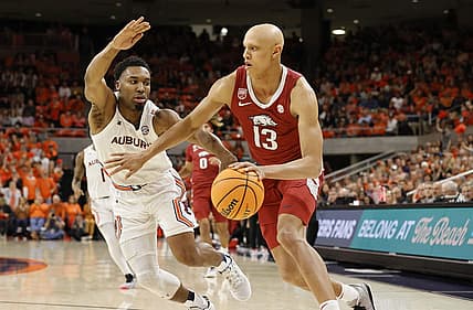 Jan 7, 2023; Auburn, Alabama, USA;  Arkansas Razorbacks guard Jordan Walsh (13) drives against Auburn Tigers forward Chris Moore (5) during the first half at Neville Arena. Mandatory Credit: John Reed-USA TODAY Sports