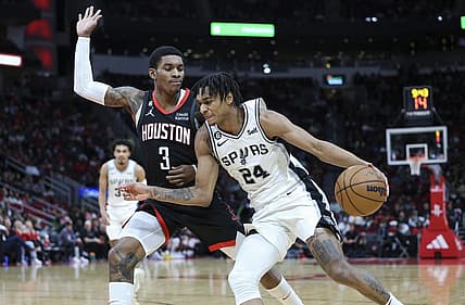 Dec 19, 2022; Houston, Texas, USA; San Antonio Spurs guard Devin Vassell (24) attempts to dribble the ball around Houston Rockets guard Kevin Porter Jr. (3) during the third quarter at Toyota Center. Mandatory Credit: Troy Taormina-USA TODAY Sports