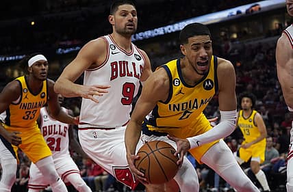 Mar 5, 2023; Chicago, Illinois, USA; Chicago Bulls center Nikola Vucevic (9) defends Indiana Pacers guard Tyrese Haliburton (0) during the first quarter at United Center. Mandatory Credit: David Banks-USA TODAY Sports