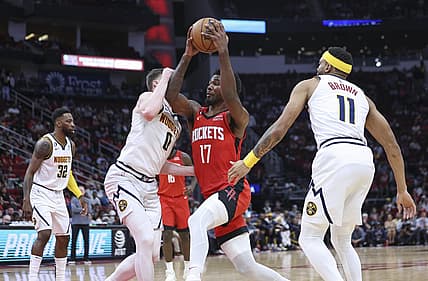 Apr 4, 2023; Houston, Texas, USA; Houston Rockets forward Tari Eason (17) drives with the ball as Denver Nuggets guard Christian Braun (0) defends during the second quarter at Toyota Center. Mandatory Credit: Troy Taormina-USA TODAY Sports