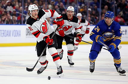 Mar 29, 2024; Buffalo, New York, USA;  Buffalo Sabres center Dylan Cozens (24) watches as New Jersey Devils center Dawson Mercer (91) makes a pass during the third period at KeyBank Center. Mandatory Credit: Timothy T. Ludwig-USA TODAY Sports