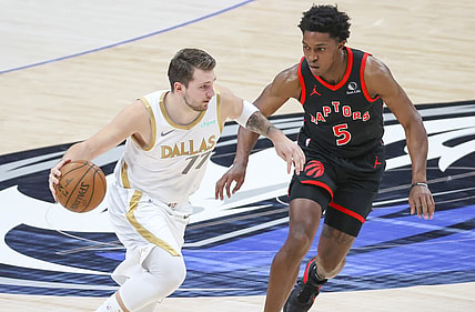 May 14, 2021; Dallas, Texas, USA;  Dallas Mavericks guard Luka Doncic (77) dribbles the ball as Toronto Raptors forward Stanley Johnson (5) defends during the first quarter at American Airlines Center. Mandatory Credit: Kevin Jairaj-USA TODAY Sports