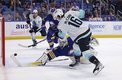 Nov 29, 2021; Buffalo, New York, USA;  Buffalo Sabres goaltender Dustin Tokarski (31) dives to try and make a save as Seattle Kraken center Jared McCann (16) takes a shot and scores during the first period at KeyBank Center. Mandatory Credit: Timothy T. Ludwig-USA TODAY Sports