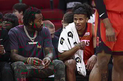 Apr 10, 2022; Houston, Texas, USA; Houston Rockets guard Jalen Green (0) talks with guard John Wall (left) during the second quarter against the Atlanta Hawks at Toyota Center. Mandatory Credit: Troy Taormina-USA TODAY Sports