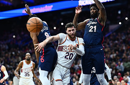 Nov 4, 2023; Philadelphia, Pennsylvania, USA; Phoenix Suns center Jusuf Nurkic (20) passes the ball between Philadelphia 76ers center Joel Embiid (21) and guard De'Anthony Melton (8) in the first quarter at Wells Fargo Center. Mandatory Credit: Kyle Ross-USA TODAY Sports