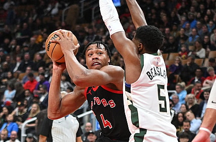 Nov 15, 2023; Toronto, Ontario, CAN;  Toronto Raptors forward Scottie Barnes (4) looks for a way past Milwaukee Bucks guard Malik Beasley (5) in the first half at Scotiabank Arena. Mandatory Credit: Dan Hamilton-USA TODAY Sports