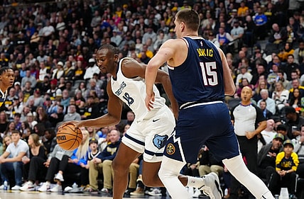 Dec 28, 2023; Denver, Colorado, USA; Memphis Grizzlies center Bismack Biyombo (18) drives at Denver Nuggets center Nikola Jokic (15) in the first quarter at Ball Arena. Mandatory Credit: Ron Chenoy-USA TODAY Sports