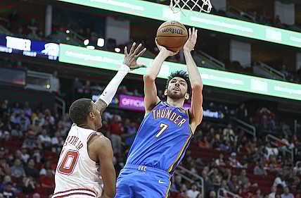 Feb 25, 2024; Houston, Texas, USA; Oklahoma City Thunder forward Chet Holmgren (7) shoots the ball as Houston Rockets forward Jabari Smith Jr. (10) defends during the third quarter at Toyota Center. Mandatory Credit: Troy Taormina-USA TODAY Sports