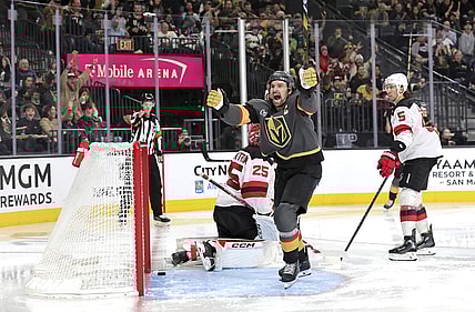 Vegas Golden Knights right wing Mark Stone, center, celebrates after scoring against New Jersey Devils goaltender Jacob Markstrom (25) during the third period of an NHL hockey game, Sunday, March 2, 2025, in Las Vegas. New Jersey Devils defenseman Brenden Dillon (5) looks on at right. (Steve Marcus/Las Vegas Sun via AP)