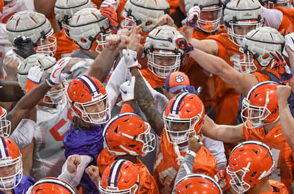 Clemson Tigers football players huddle
