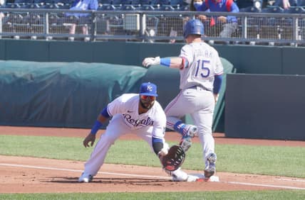 Apr 1, 2021; Kansas City, Missouri, USA; Kansas City Royals first baseman Carlos Santana (41) makes the out on Texas Rangers second baseman Nick Solak (15) at first base in the first inning at Kauffman Stadium. Mandatory Credit: Denny Medley-USA TODAY Sports