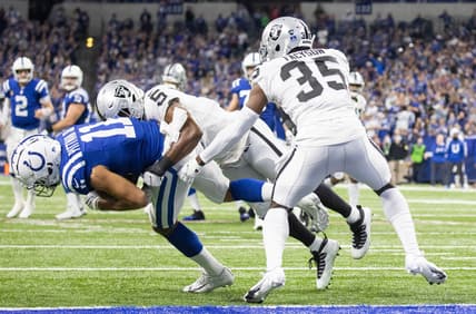 Jan 2, 2022; Indianapolis, Indiana, USA;  Indianapolis Colts wide receiver Michael Pittman (11) catches the ball and is stopped on the one yard line by Las Vegas Raiders linebacker Divine Deablo (5) in the first half at Lucas Oil Stadium. Mandatory Credit: Trevor Ruszkowski-USA TODAY Sports